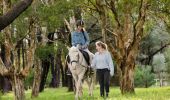 Woman enjoying a horse riding experience with Eastside Riding Academy in Centennial Park, Sydney